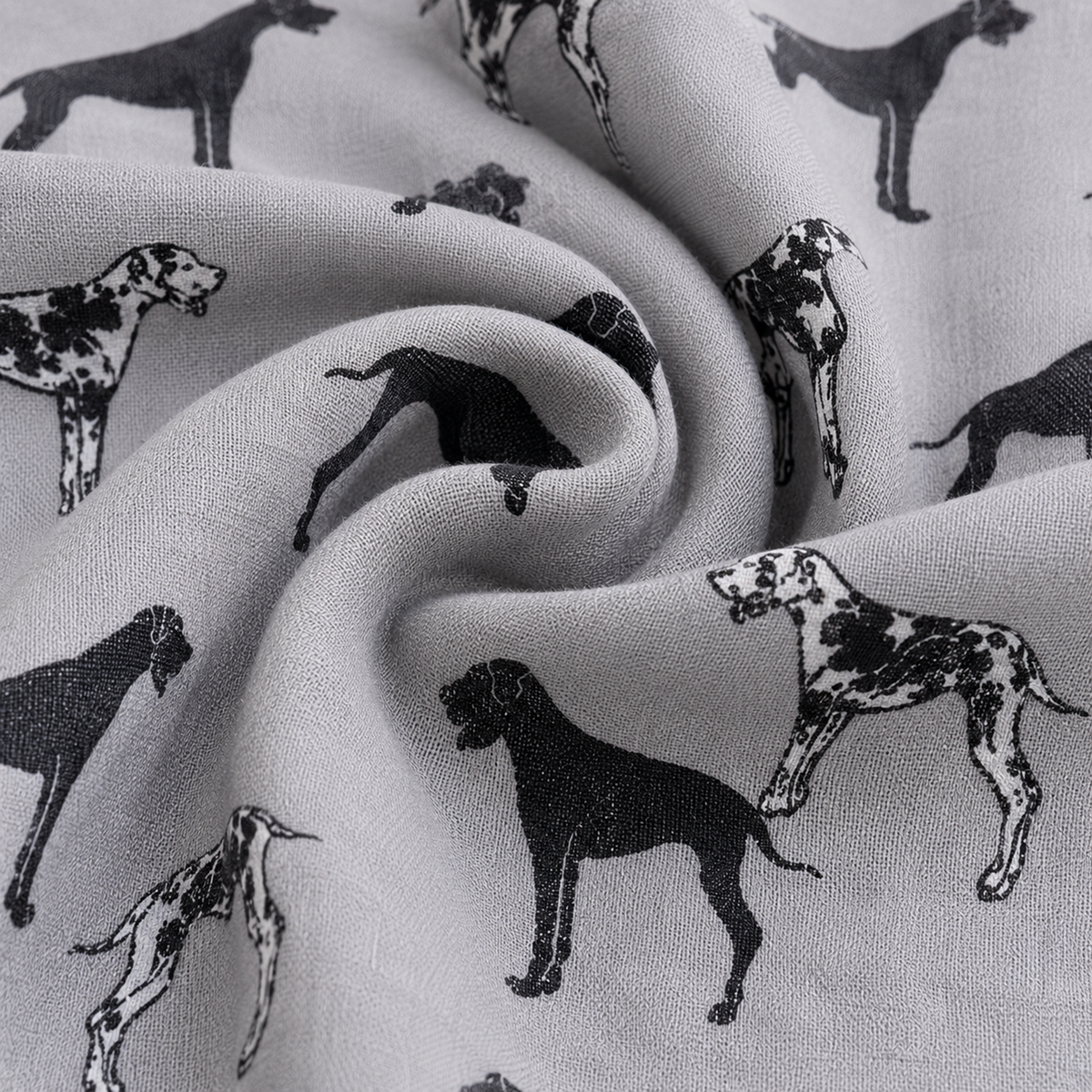 A close-up of light grey scarf with a repeating black Great Dane dog print, shown in soft folds to highlight the material texture and pattern.