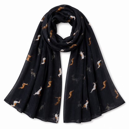 A navy lightweight scarf with an all over print of greyhound whippet  dogs in white, brown, and grey, displayed on a clean white background.
