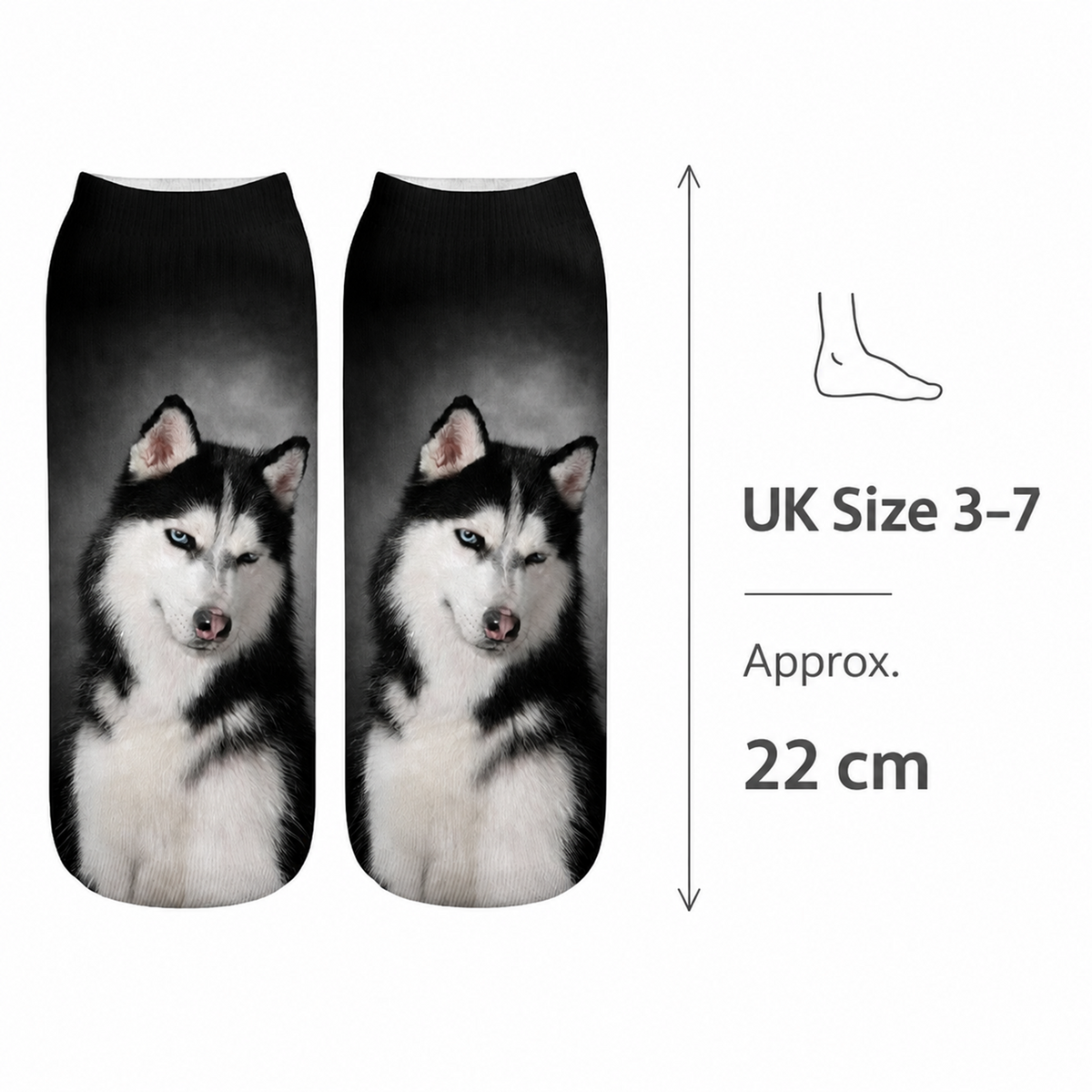 A pair of low-cut socks with a printed husky dog design on a black and grey gradient background, shown next to a size guide indicating UK Size 3-7 and 22 cm length.