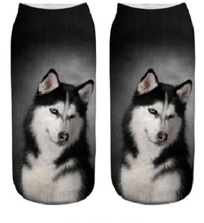 Two socks with husky dog design on a dark background