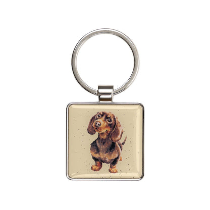 Keychain with a dachshund illustration on a beige background