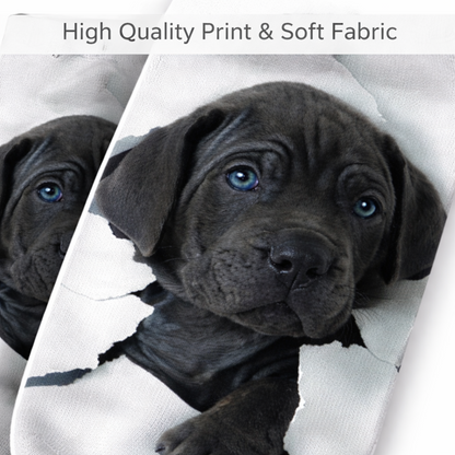 A close-up of a printed sock design showing a black Labrador puppy peeking through a torn white background, with text at the top reading 'High Quality Print & Soft Fabric'.