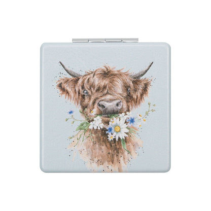 Compact mirror with a highland cow design on a light blue background