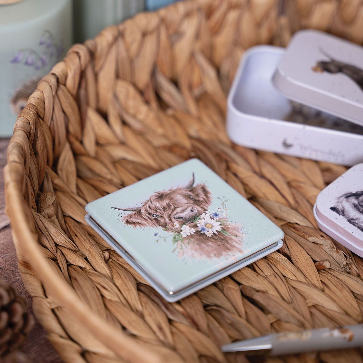 Small notebook with a highland cow illustration on a woven basket