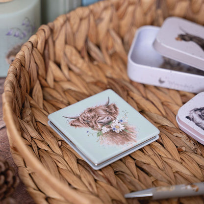 Small notebook with a highland cow illustration on a woven basket