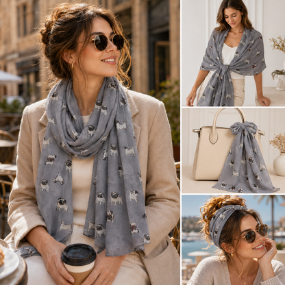 A woman wearing a grey patterned scarf with pug dog prints in an outdoor cafe setting, shown alongside three smaller product views: the scarf tied around her upper body, draped over a cream handbag, and styled as a headband. The scarf pattern is clearly visible against the neutral background.