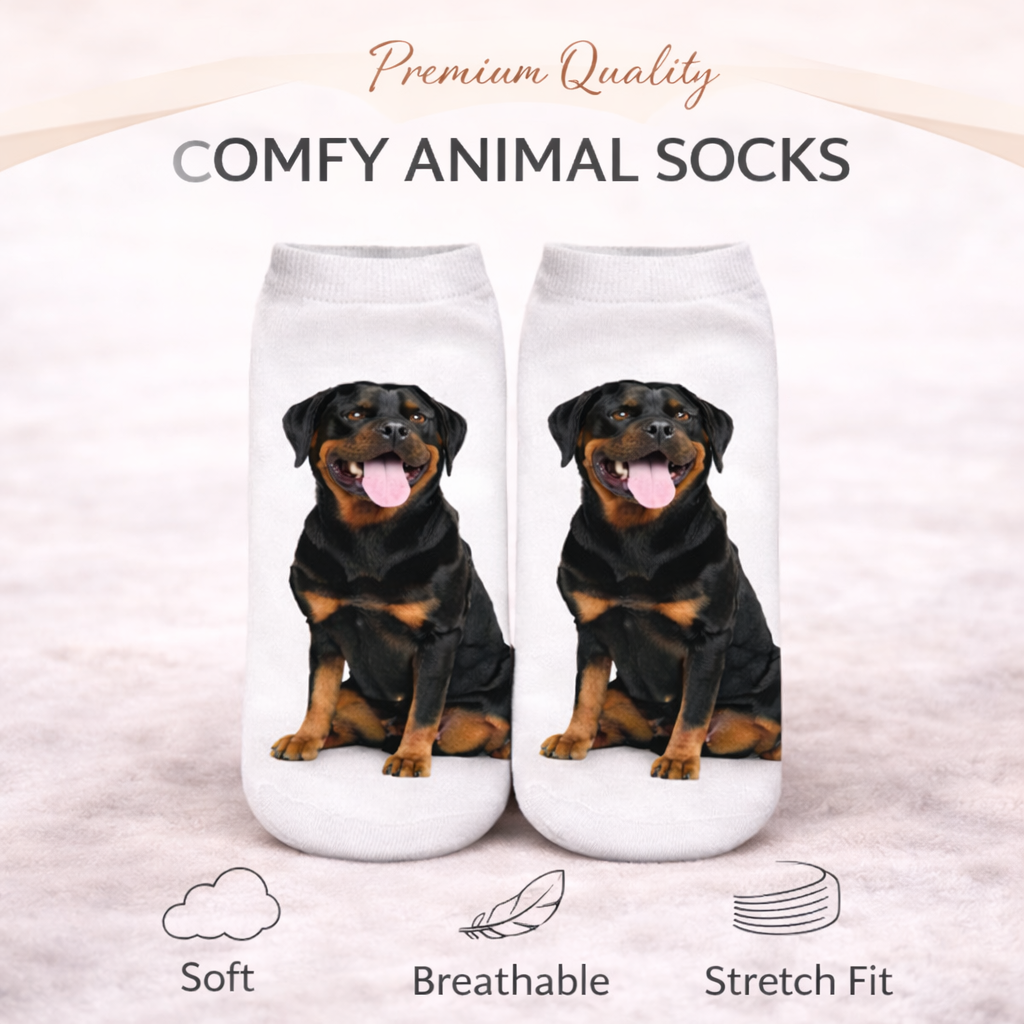 A pair of white ankle socks featuring printed images of a Rottweiler dog, displayed on a light beige background with promotional text and feature icons.
