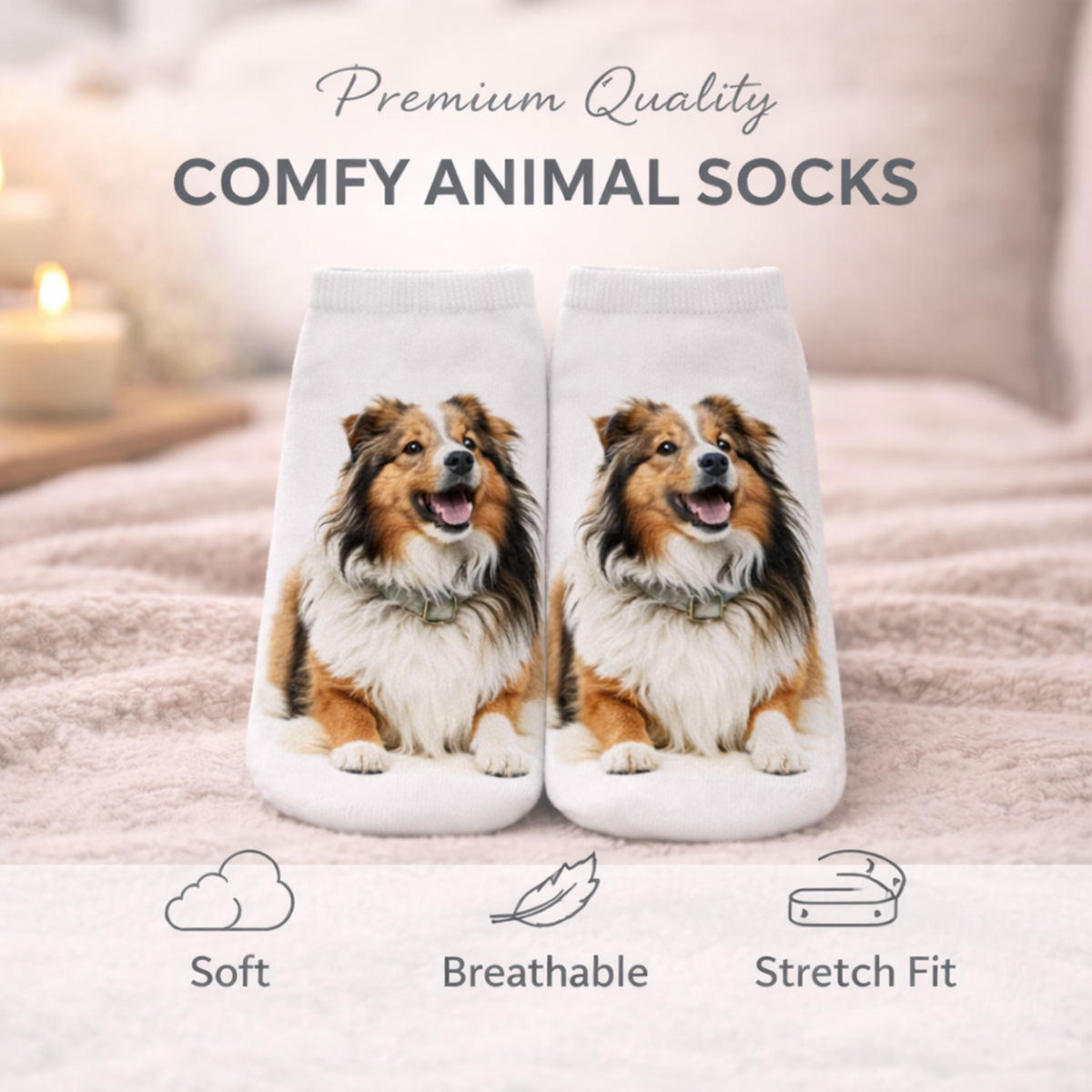 A pair of white ankle socks printed with a smiling Shetland Sheepdog, displayed on a soft pink blanket with a blurred bedroom background. Text at the top reads 'Premium Quality COMFY ANIMAL SOCKS' and icons at the bottom highlight soft, breathable, and stretch-fit qualities. 