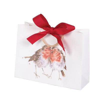 A white paper gift bag with a red satin bow and a watercolor robin bird illustration on the front, set against a plain white background.