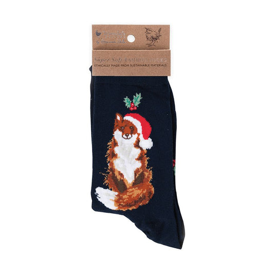 A single dark navy sock with a printed illustration of a brown and white fox wearing a red Santa hat, attached to a brown paper header card, on a plain white background.