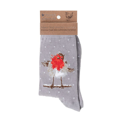 A pair of grey knit socks in retail packaging with a brown paper header card. The socks feature a printed design of a robin bird with a bright red breast, white feathers, and brown details, standing on a branch against a snowy background with white dots.