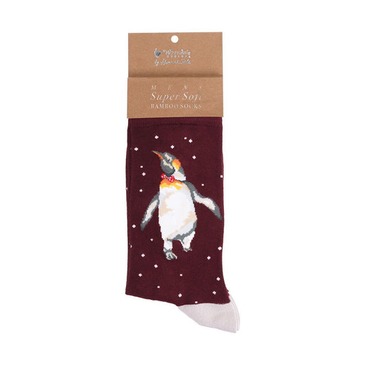 A single pair of packaged bamboo socks on a white background. The socks are dark maroon with a printed penguin wearing a red bow tie and white stars, and a brown paper header card at the top.