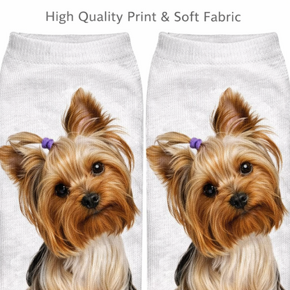 A pair of white knit socks featuring a printed illustration of a Yorkshire Terrier dog with tan and cream fur and small purple hair bows, shown against a white background with the text 'High Quality Print & Soft Fabric' at the top.